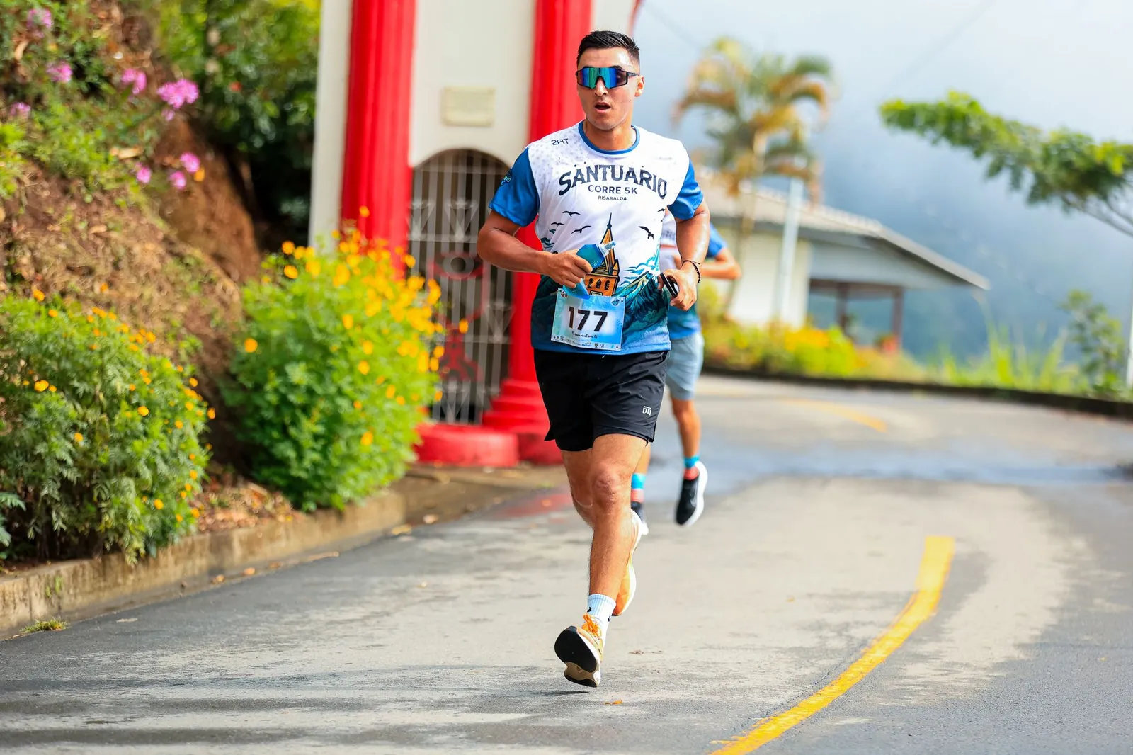Beginner runner on a paved trail maintaining an easy conversational pace during a morning training run