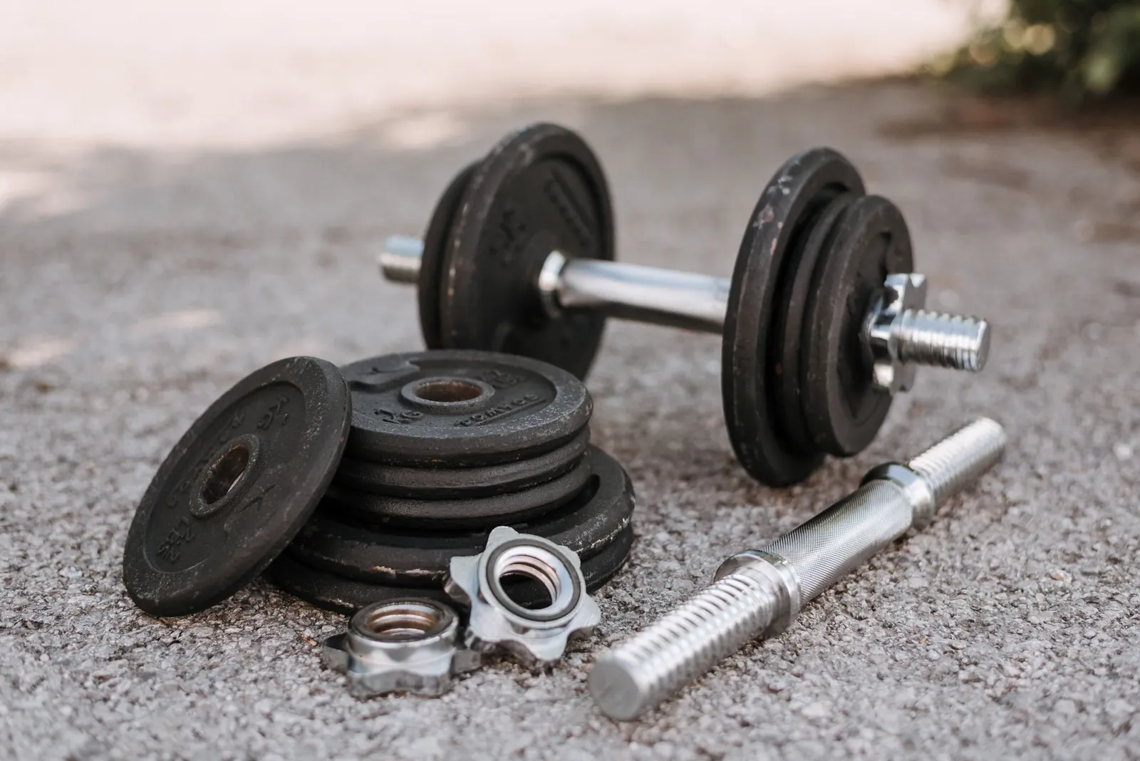 Dial-based adjustable dumbbell showing weight selector and increment markings at the 25-pound setting