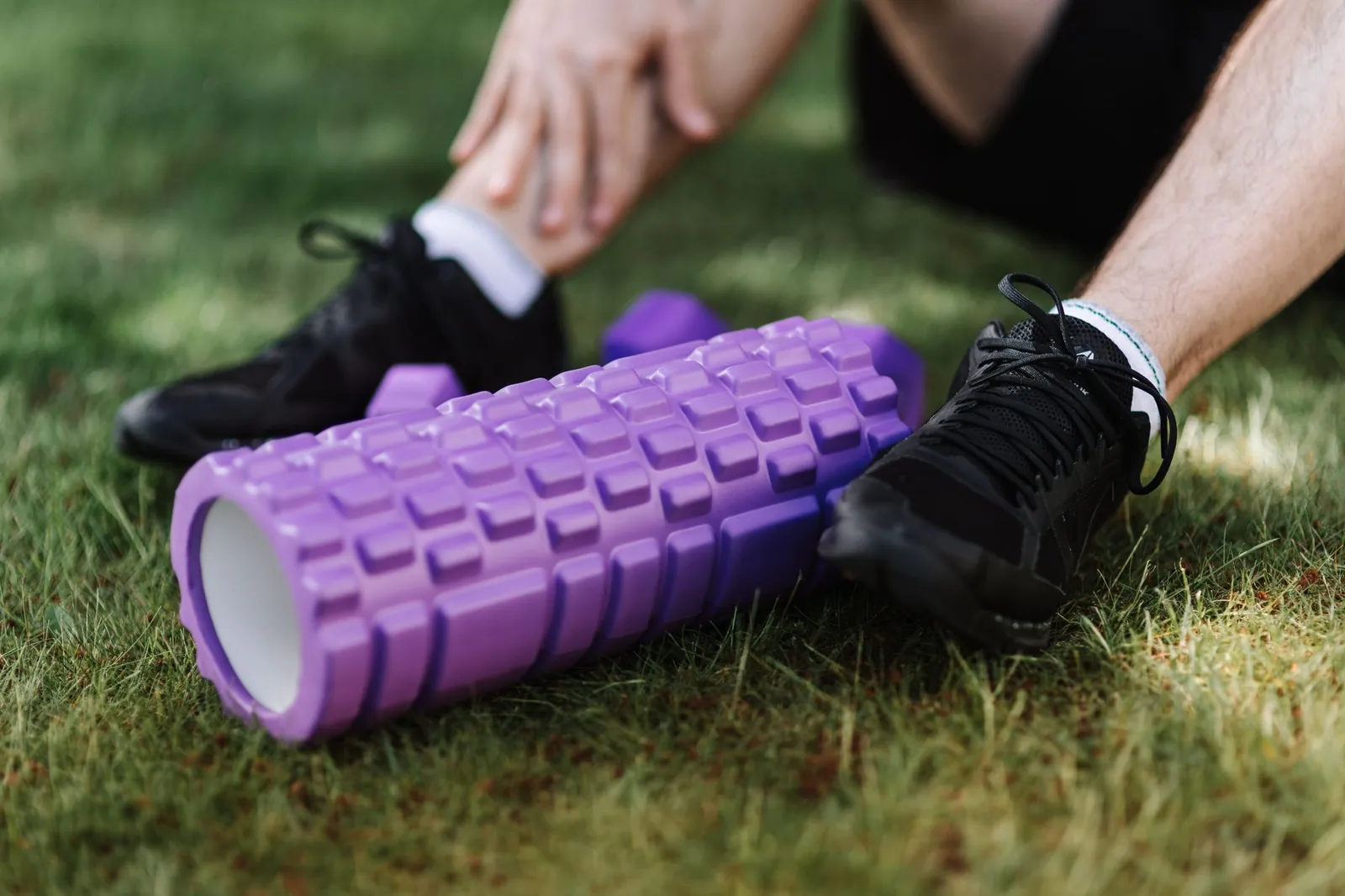 Athlete foam rolling quadriceps at a slow, controlled pace after a lower-body workout
