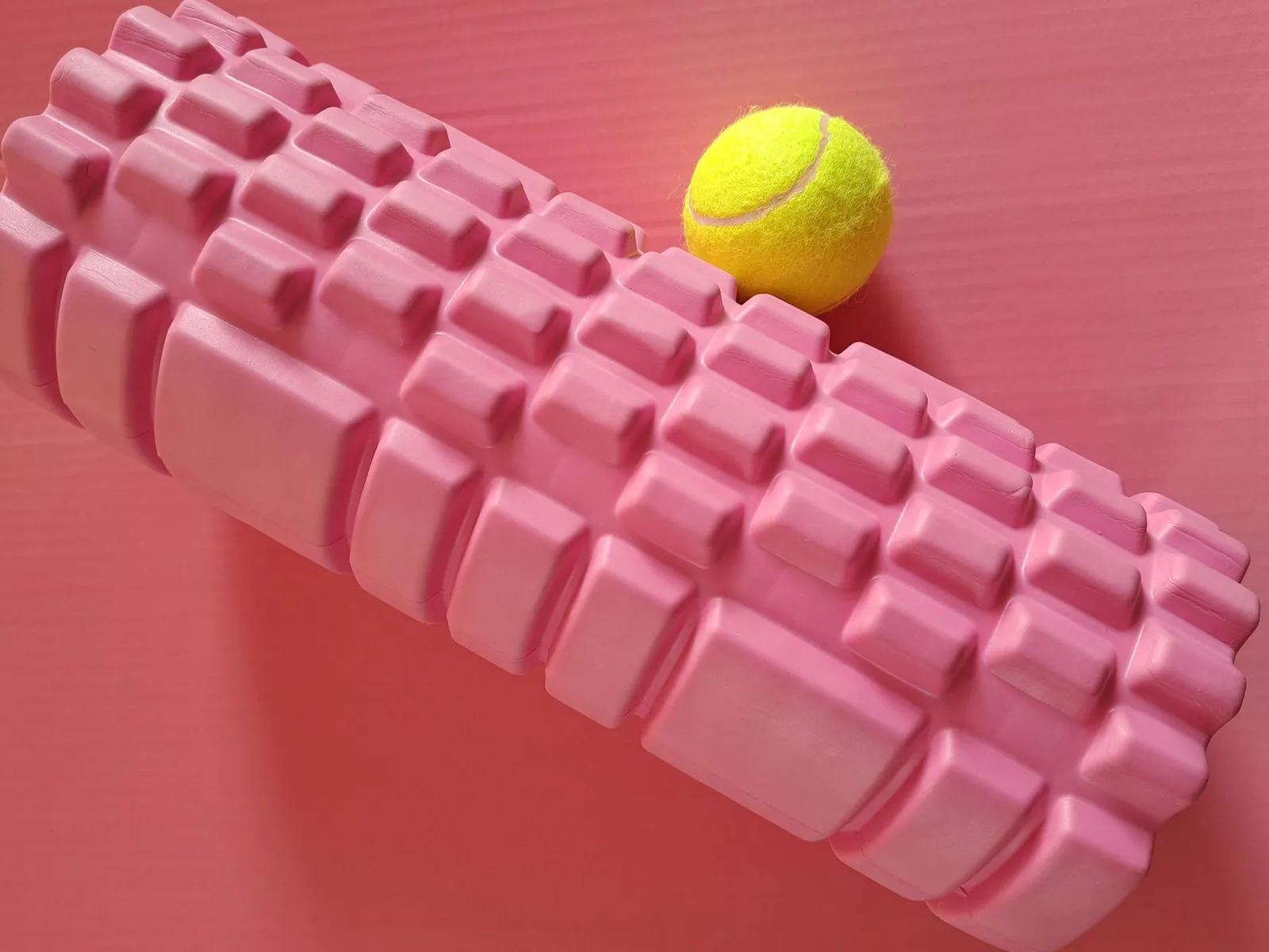 Athlete using a high-density foam roller on quadriceps after a run