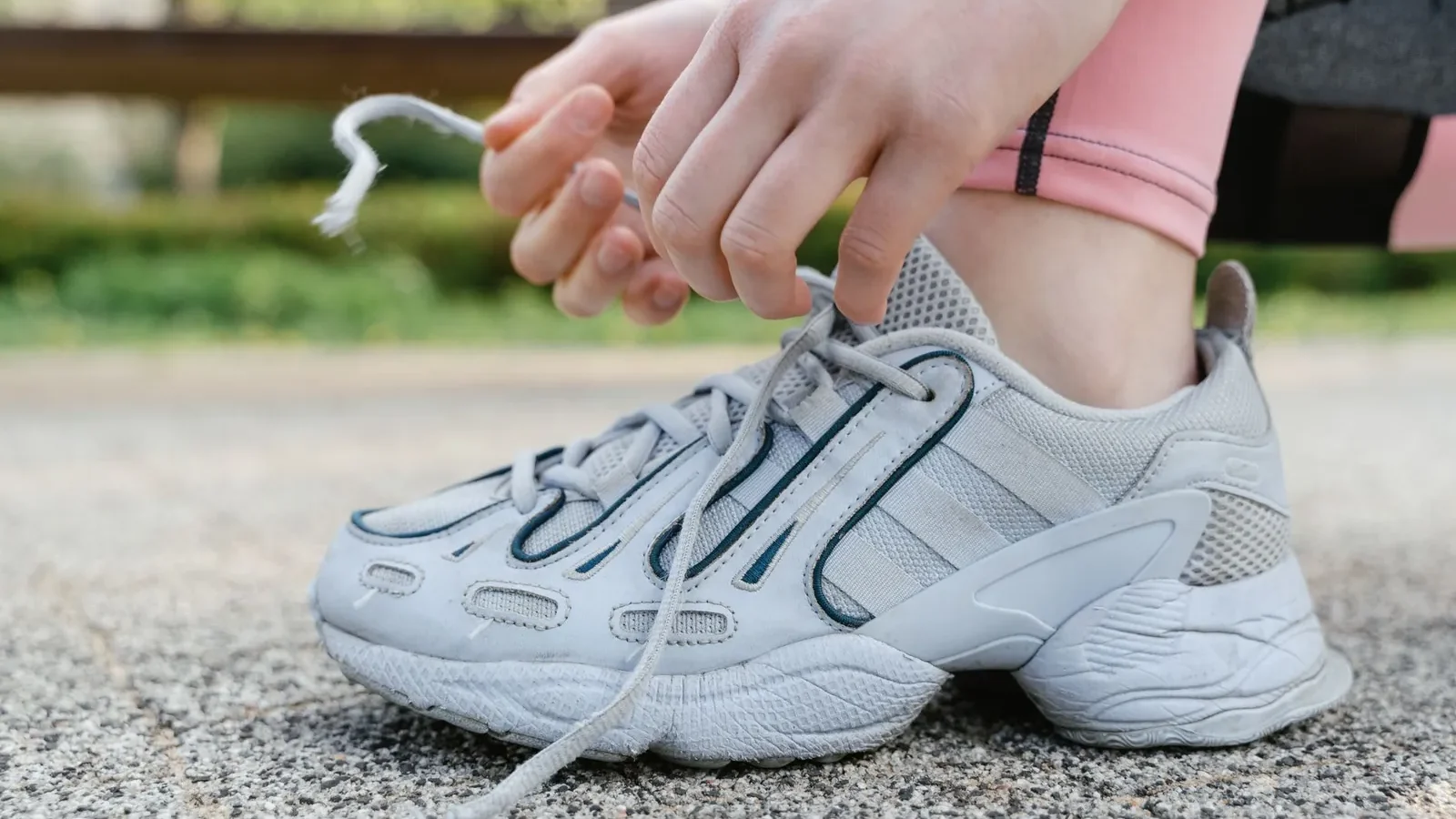 Cross-section of a stability running shoe showing the firm medial post foam wedge on the inner midsole, designed to control overpronation in flat feet