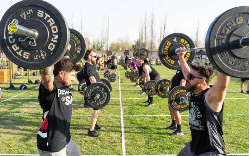 Athlete performing a deadlift with proper form, bar over mid-foot, back straight and shoulders engaged