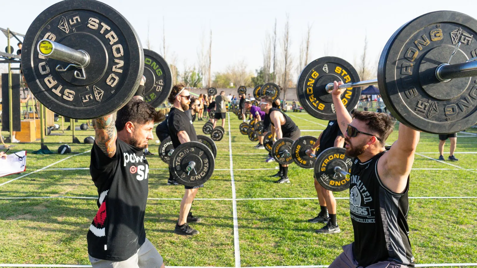 Athlete performing a deadlift with proper form, bar over mid-foot, back straight and shoulders engaged