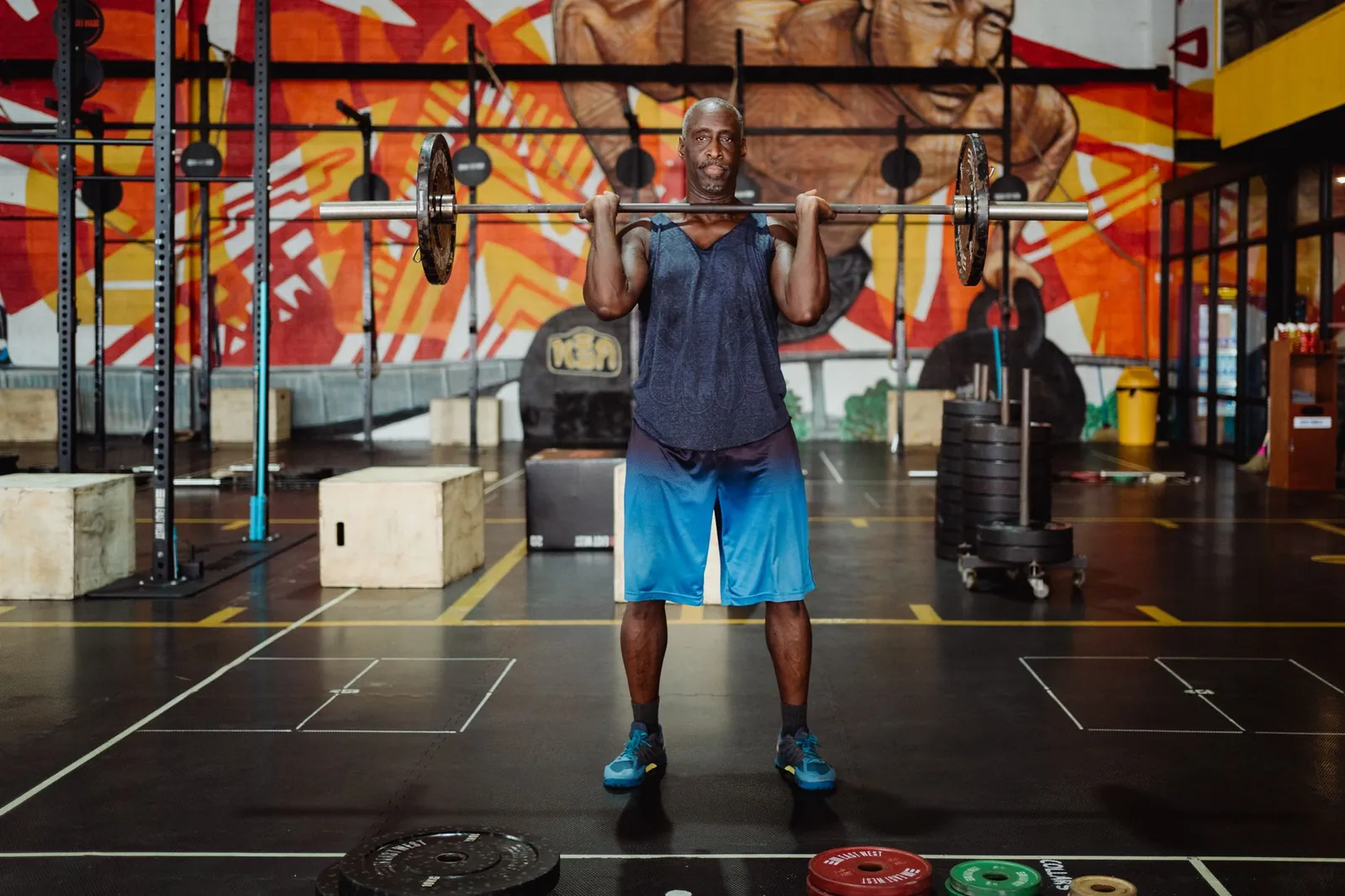 Athlete performing a deadlift with proper form, bar over mid-foot, back straight and shoulders engaged