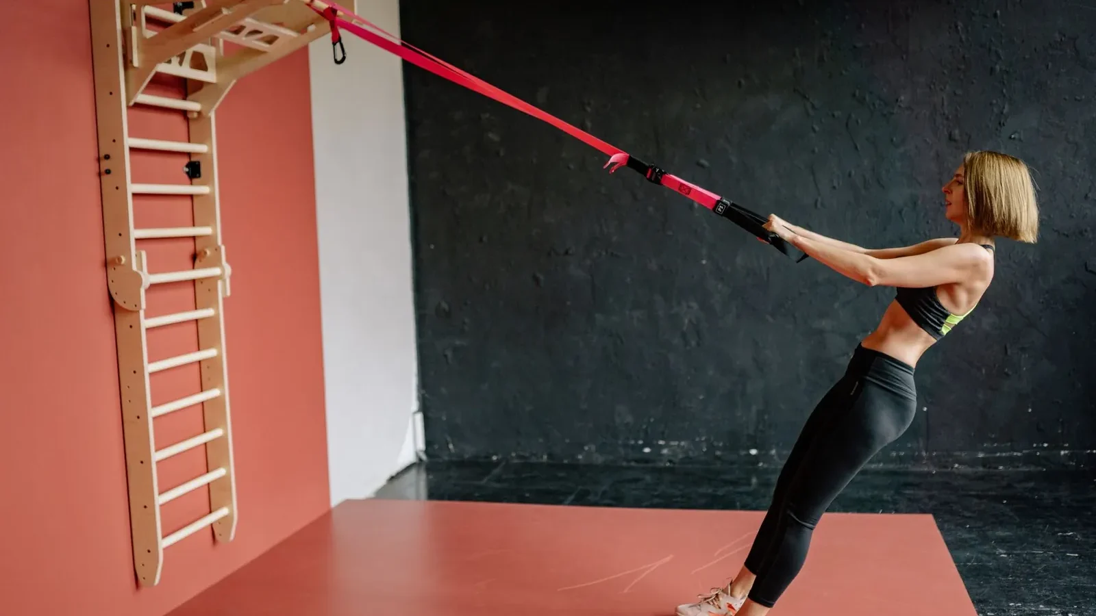 Person performing a push-up with elbows at 45 degrees in a clear home workout space