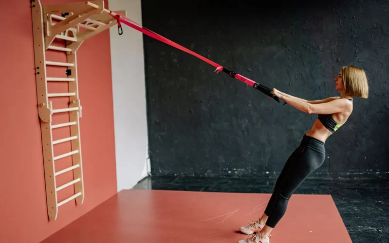 Person performing a push-up with elbows at 45 degrees in a clear home workout space