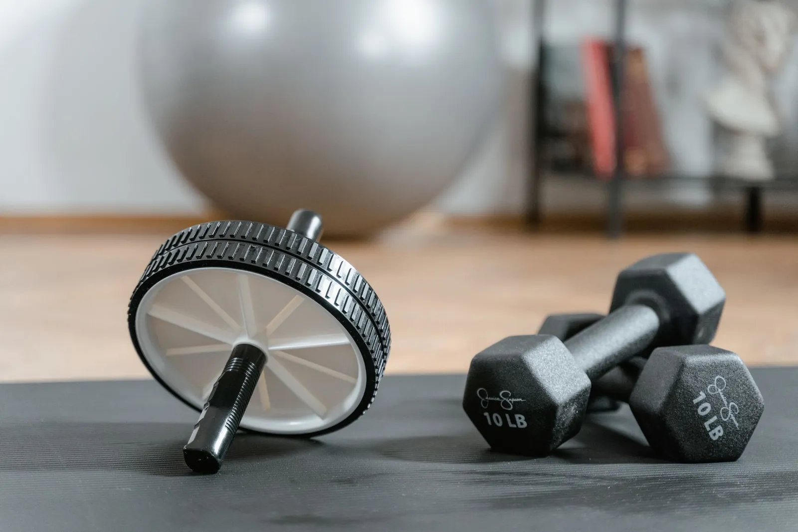 Person performing a push-up with elbows at 45 degrees in a clear home workout space