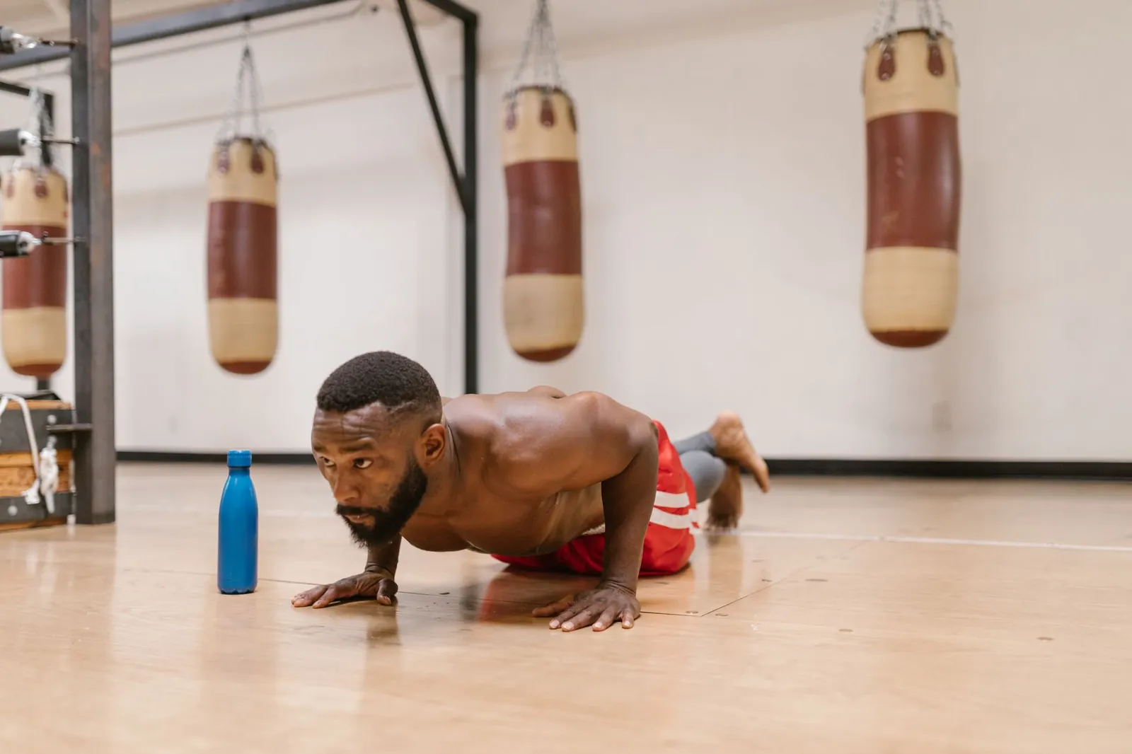 Handwritten training log tracking sets, reps, and exercise progressions for a bodyweight workout program