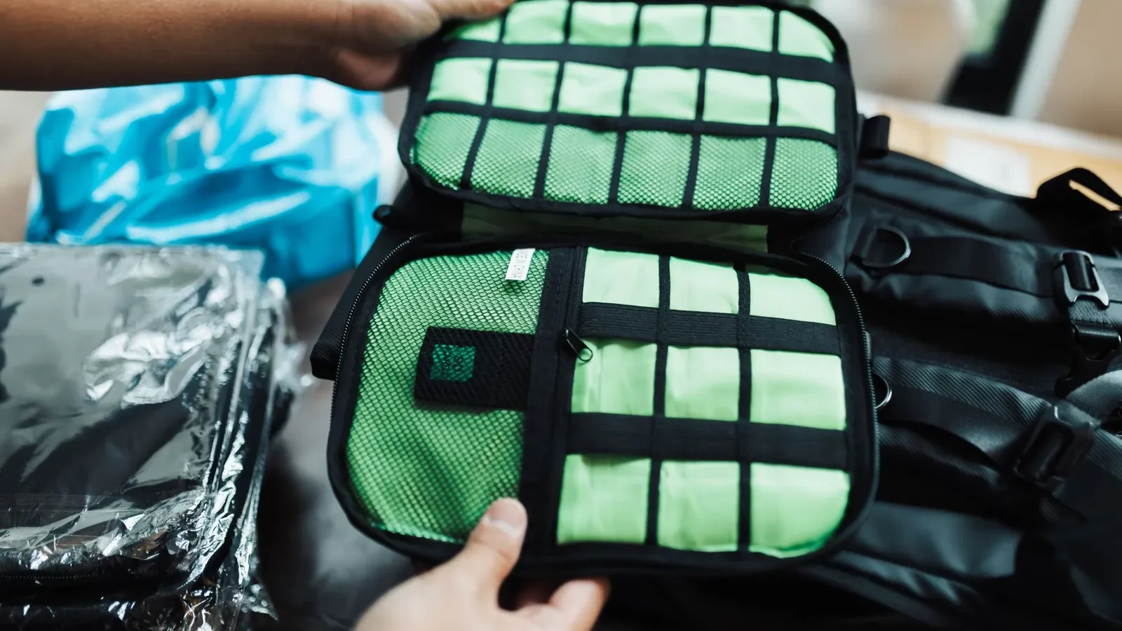 Hiker adjusting hip belt on properly fitted backpack on forest trail