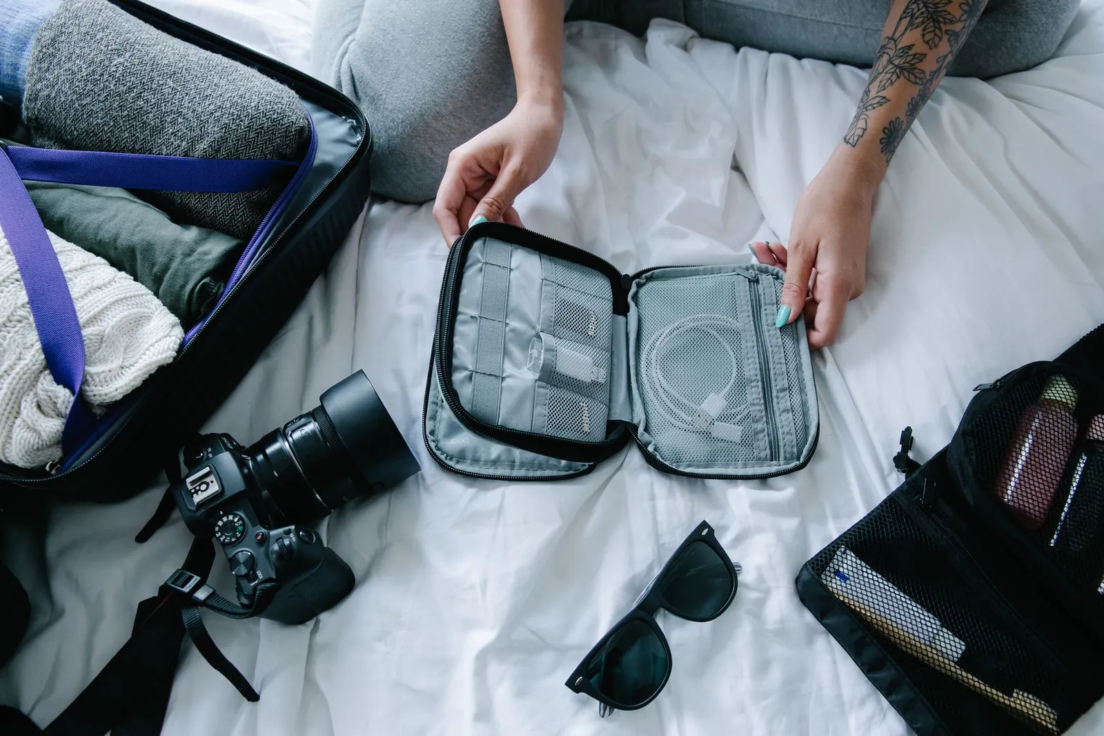Overhead view of organized backpack contents with compression sacks and gear arranged by weight zones