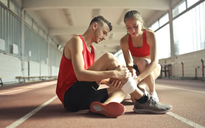 Runner reviewing weekly mileage totals on a training app to stay within the 10% progression rule