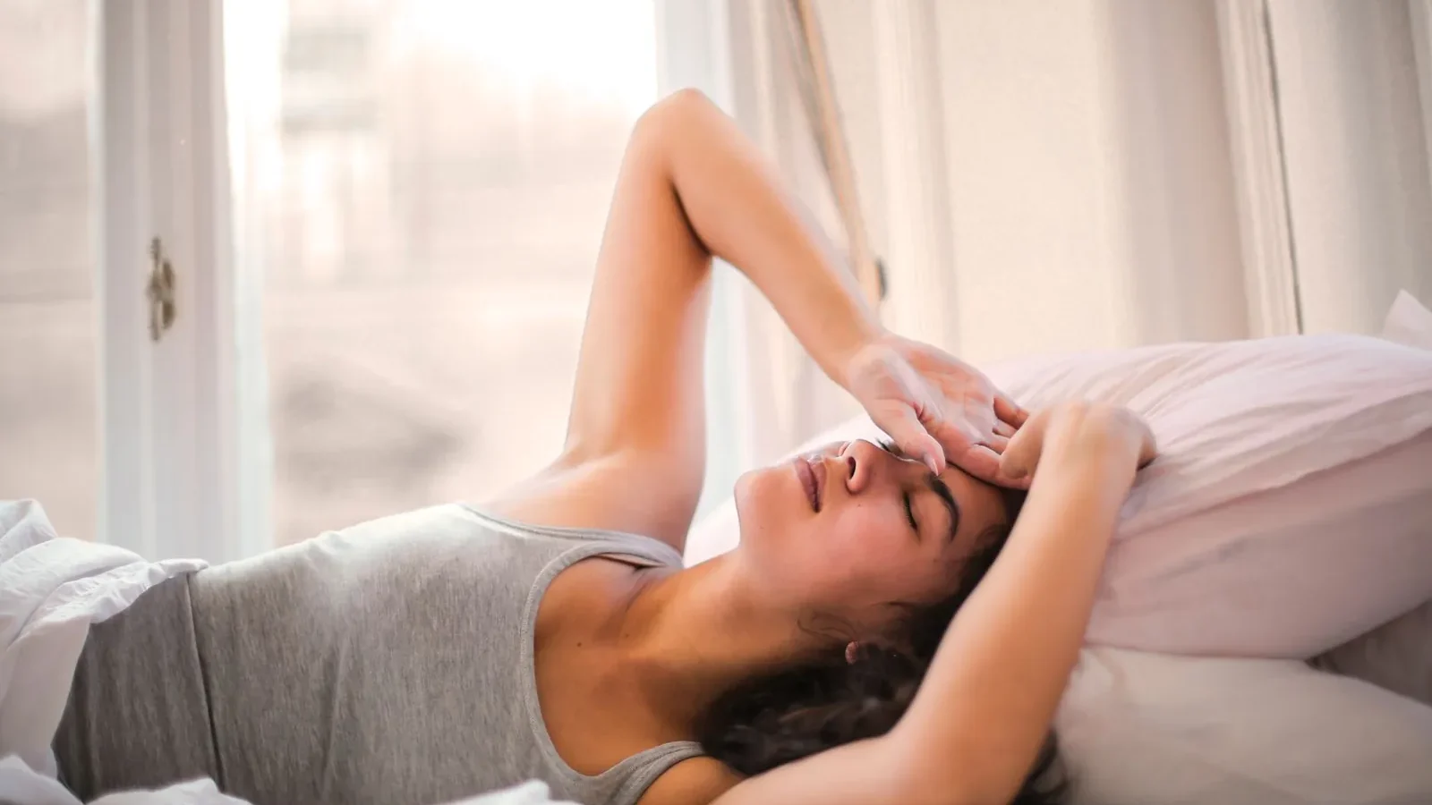 Athlete sleeping in bed during afternoon recovery nap