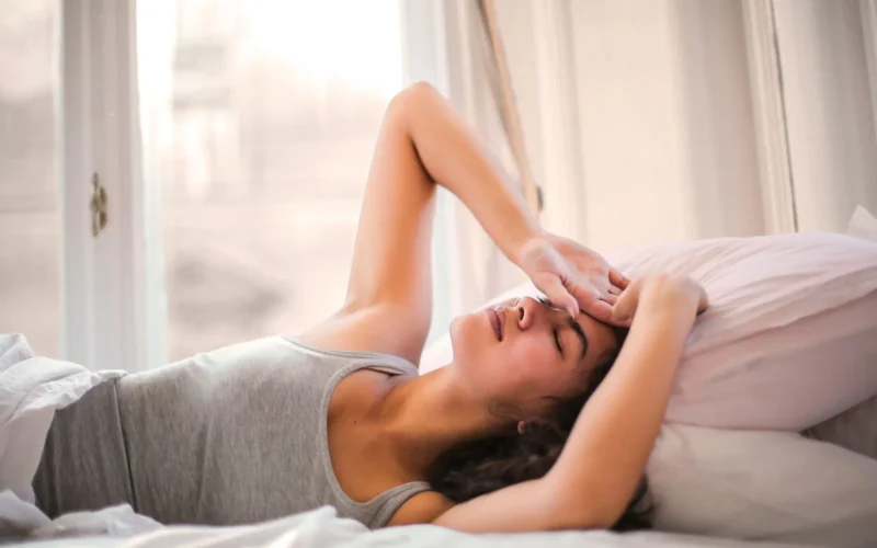 Athlete sleeping in bed during afternoon recovery nap