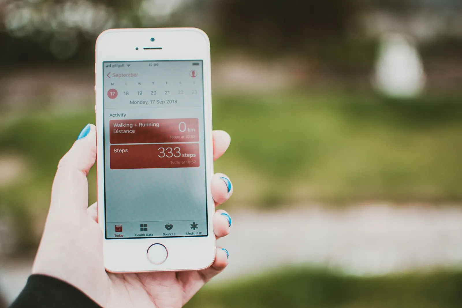 Smartphone displaying a fitness tracking app with weekly progress charts and workout logs