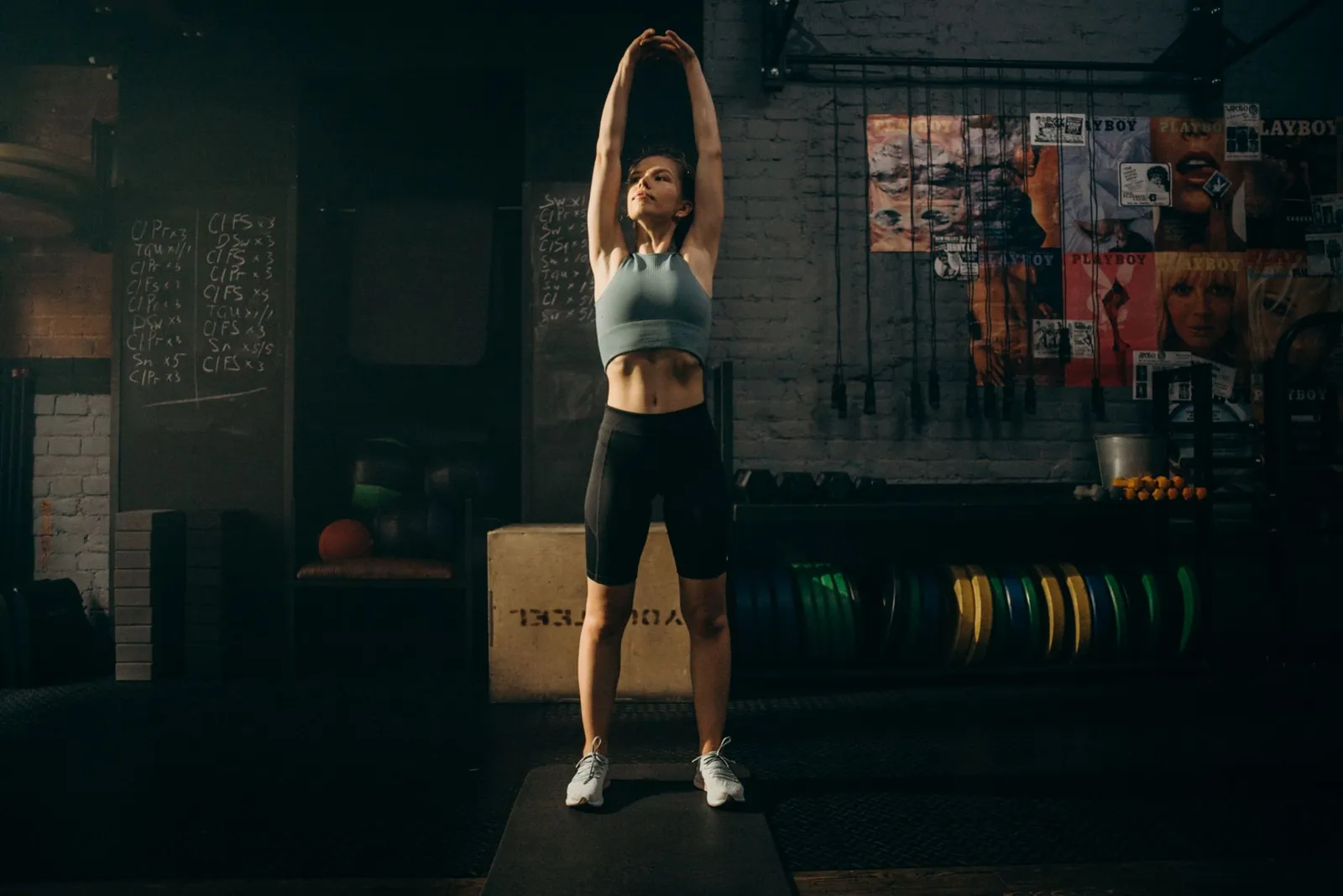 Lifter performing dynamic leg swings as part of a structured warm-up before a strength training session