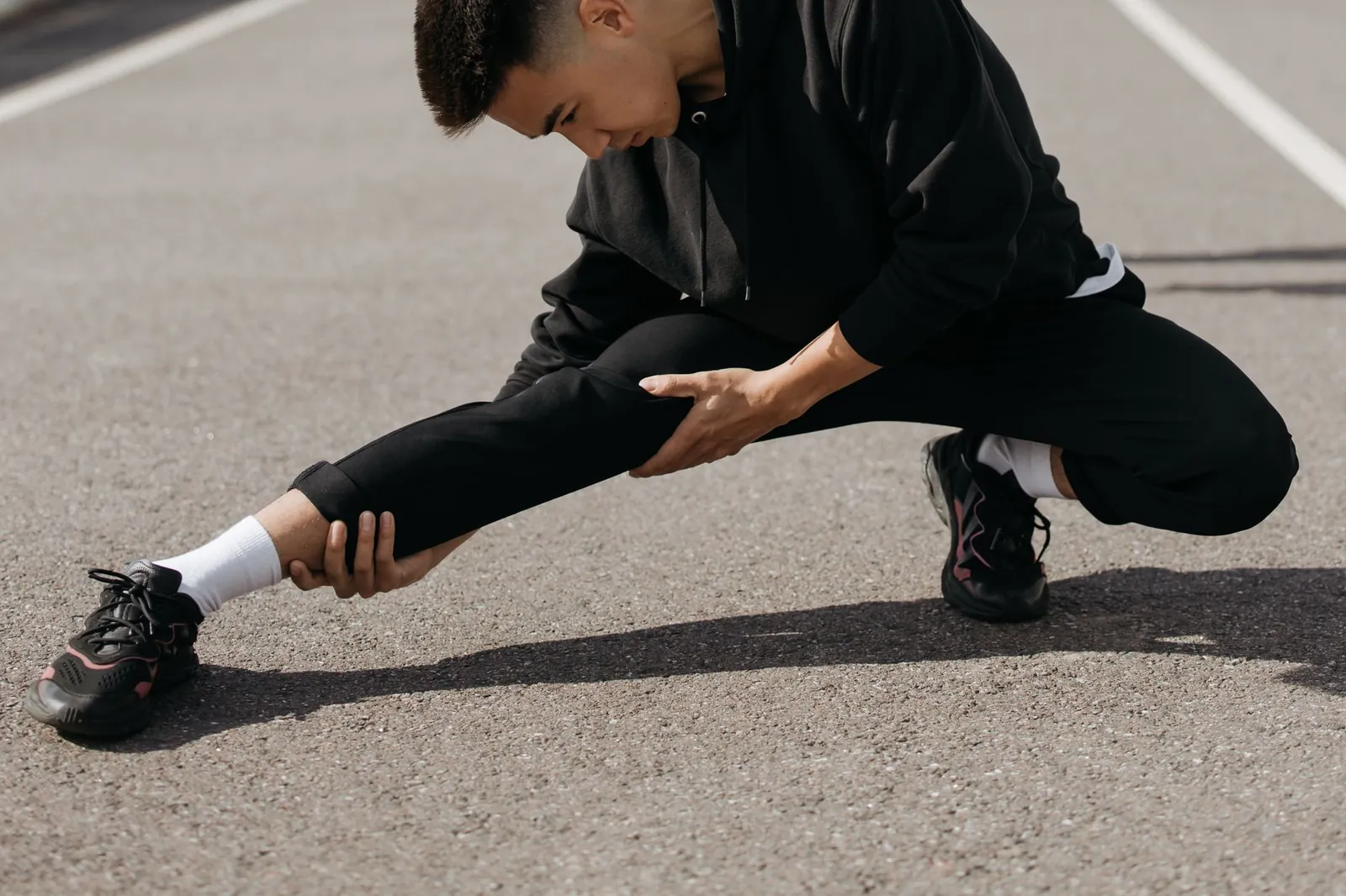 Athlete performing glute bridges on a gym floor as lower-body activation work before squats