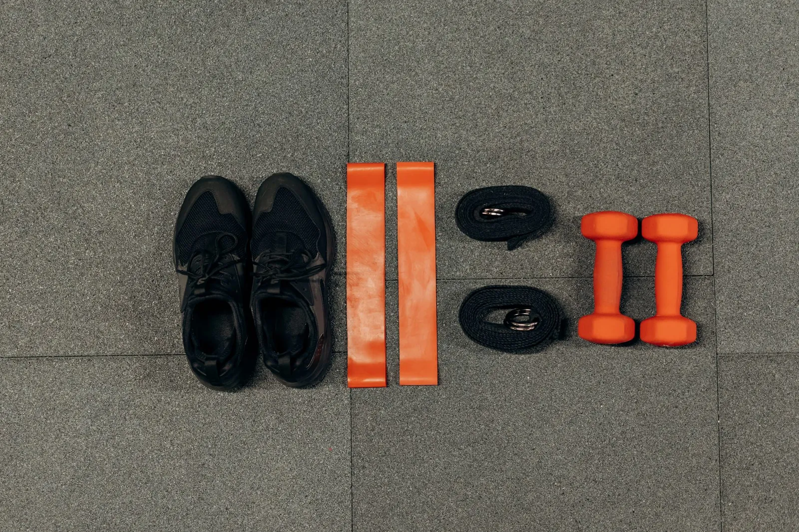 Side-by-side demonstration of a dumbbell bicep curl versus a resistance band curl, showing the difference in resistance curve at the top and bottom of each movement