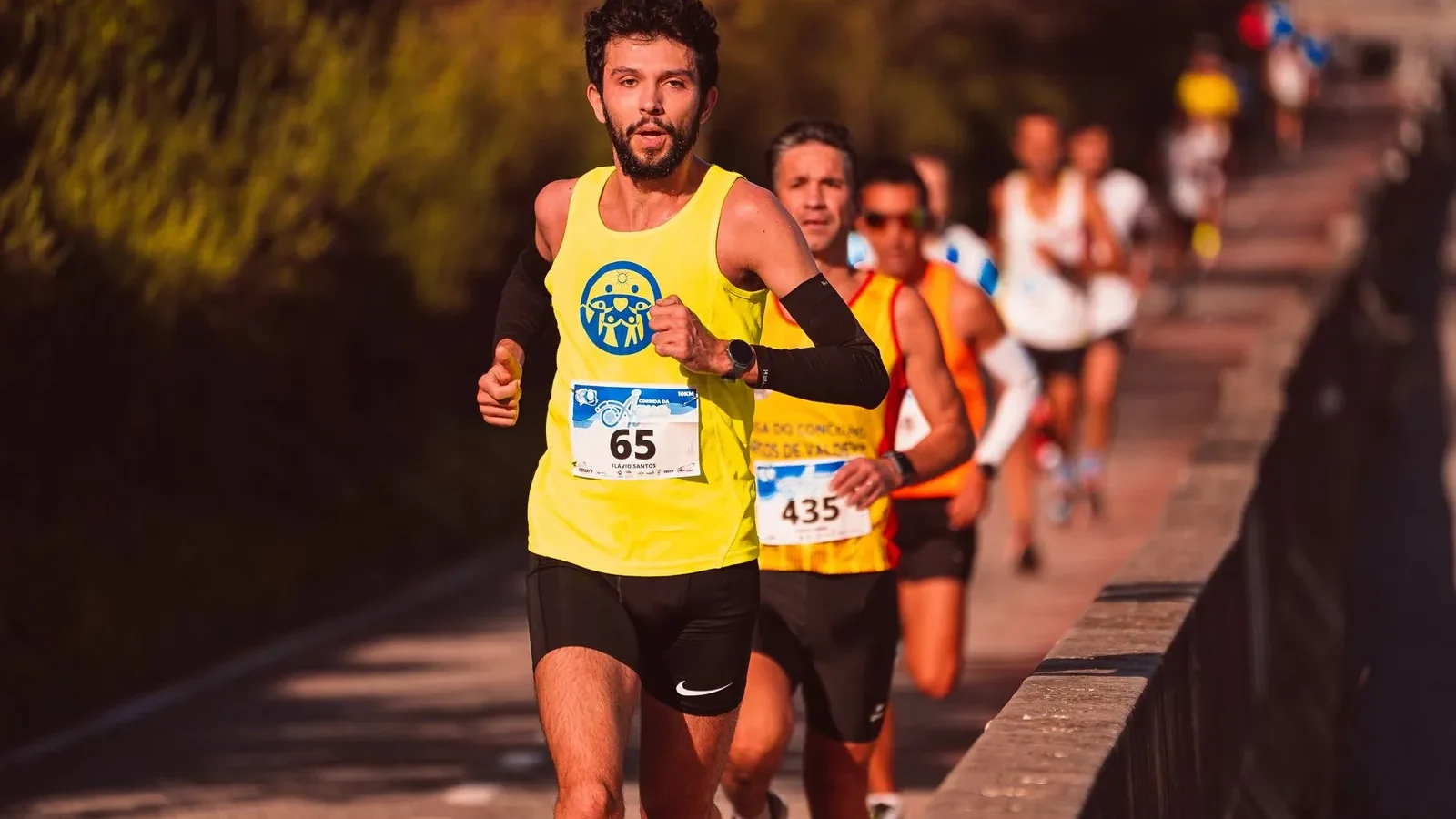 Runner checking GPS watch to measure running pace during an easy-paced workout