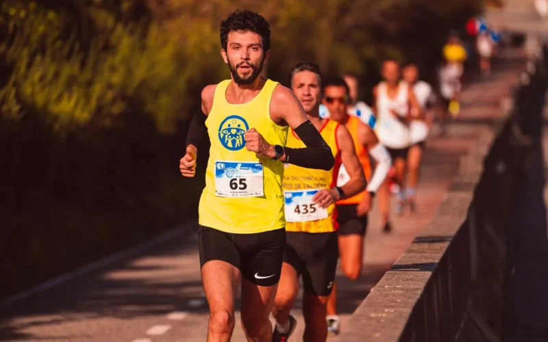 Runner checking GPS watch to measure running pace during an easy-paced workout