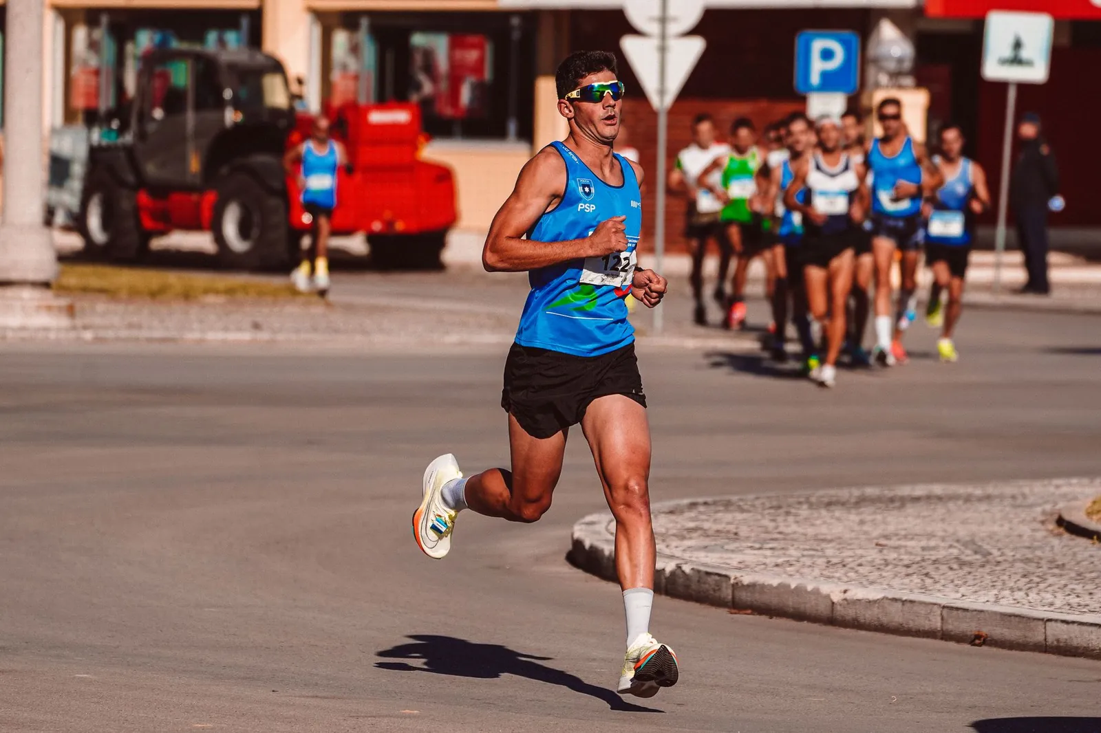 Beginner runner performing tempo pace workout on a measured track with proper form