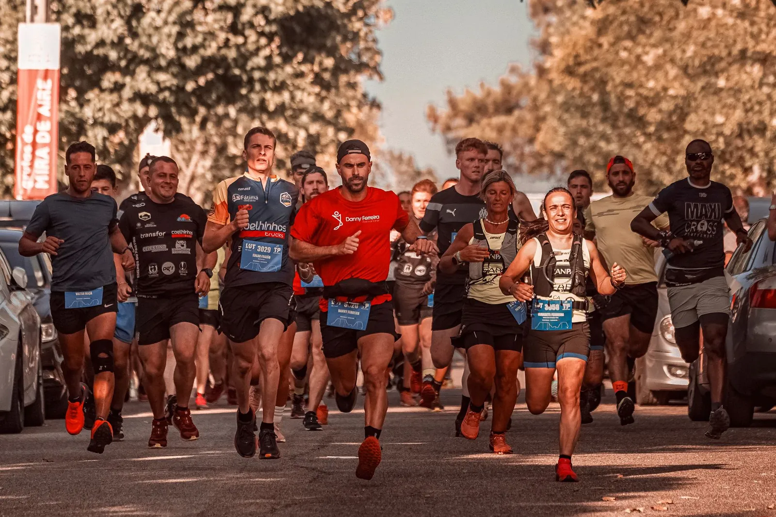 Runners crossing the finish line at a spring marathon in April morning light