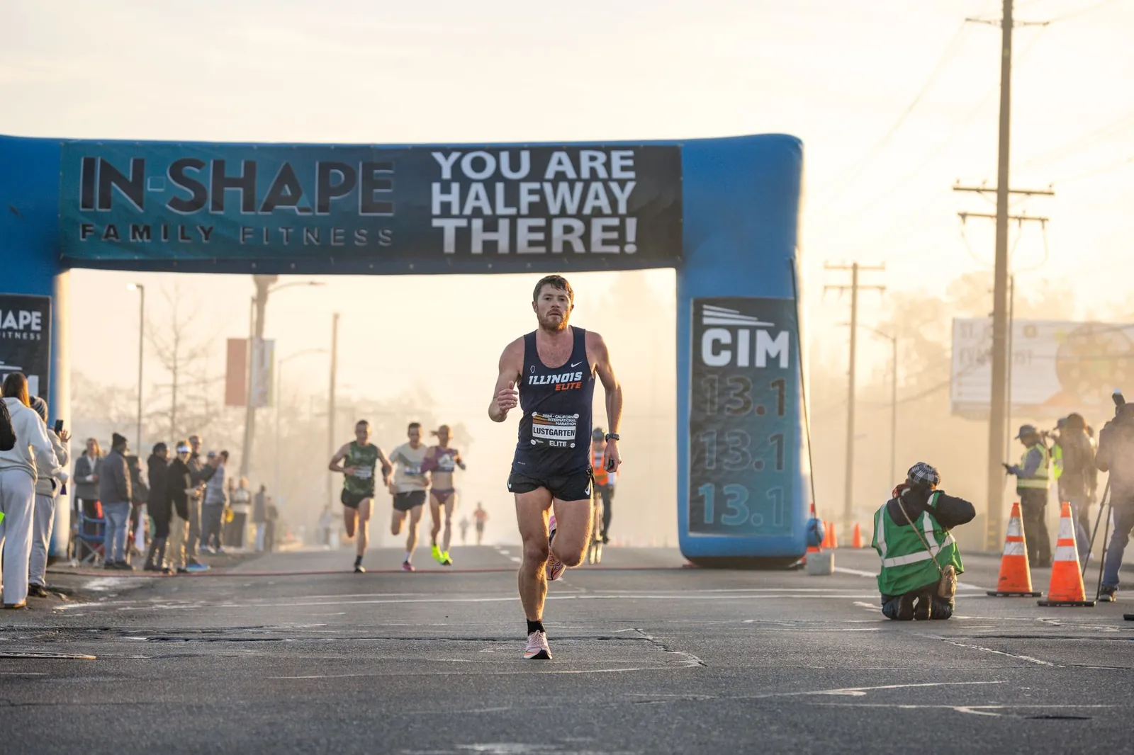 Fall marathon runners in autumn foliage with race bibs and timing chips