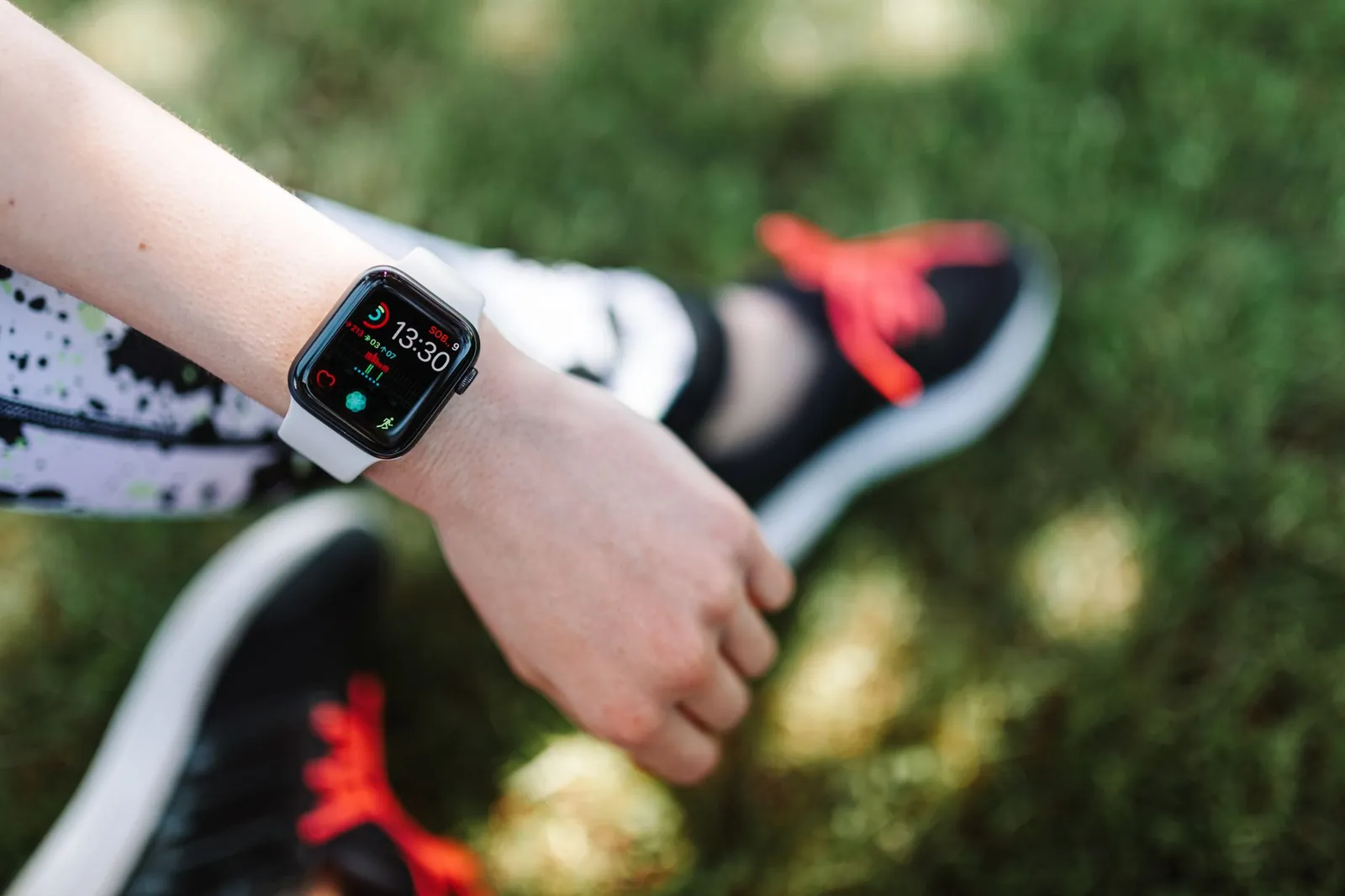 Cyclist riding at zone 2 pace on a flat road, heart rate monitor visible on wrist